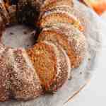 An overhead view of a sliced apple cider donut cake.