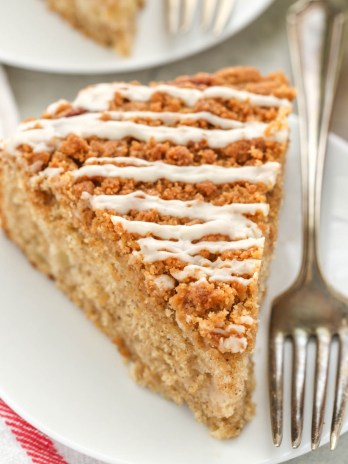 A slice of apple coffee cake sitting on a white plate.