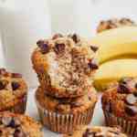 Banana chocolate chip muffins stacked on top of each other.