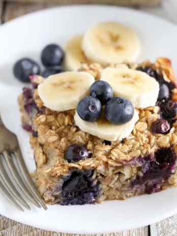 A slice of blueberry banana baked oatmeal on a white plate.
