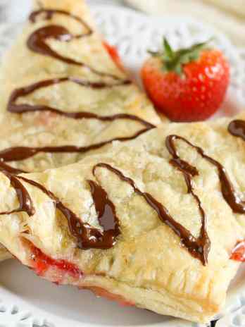Puff pastry stuffed with chocolate, Nutella, and fresh strawberries. These Chocolate Strawberry Nutella Turnovers make one delicious and decadent dessert!