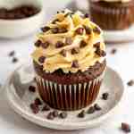 A chocolate cupcake topped with cookie dough frosting.