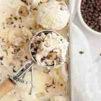An overhead view of cookie dough ice cream with a scoop of ice cream resting on top.