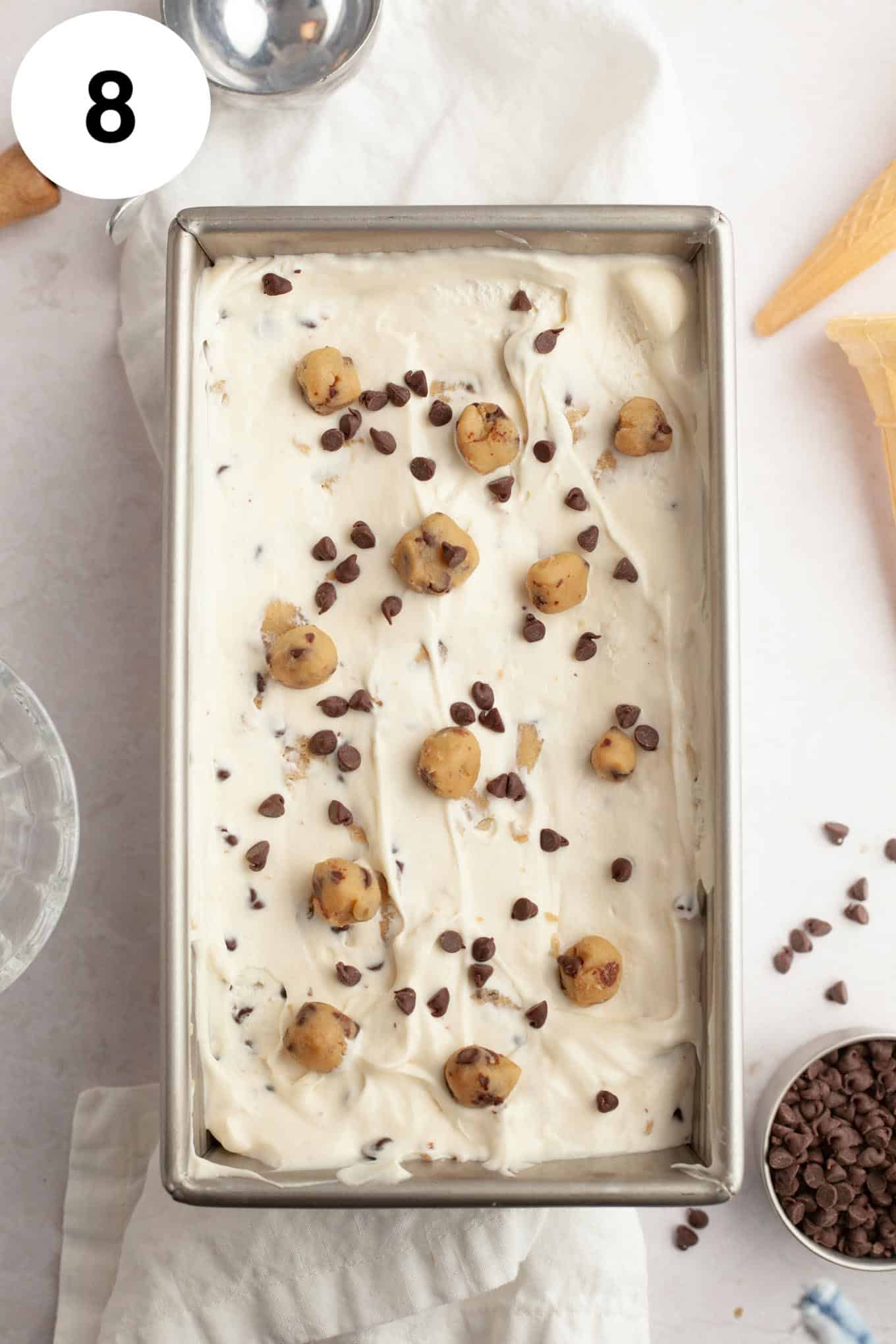 An overhead view of cookie dough ice cream in a metal loaf pan. 
