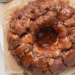 An overhead view of monkey bread on a piece of brown parchment paper.
