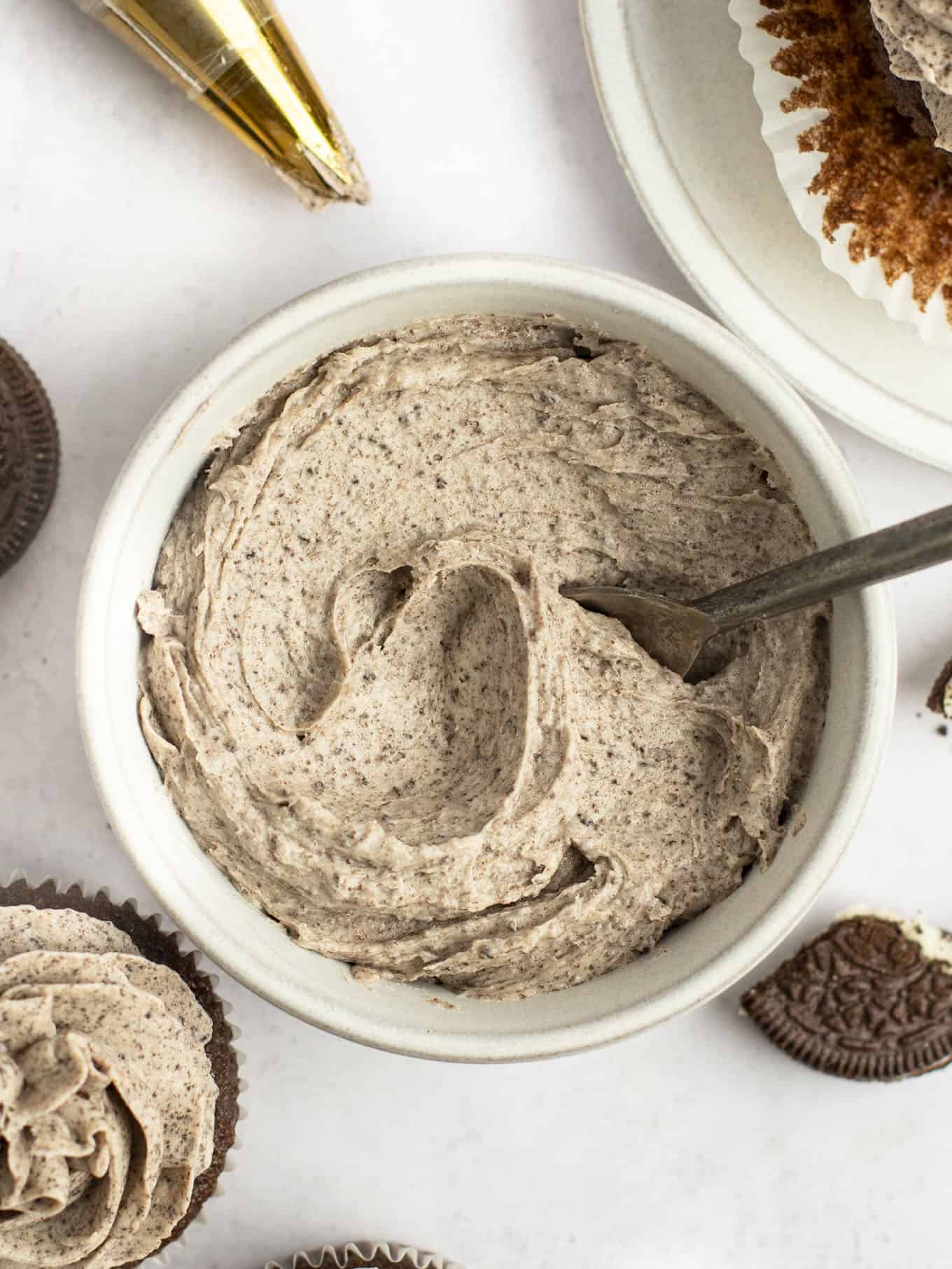 An overhead view of Oreo frosting in a white bowl. 