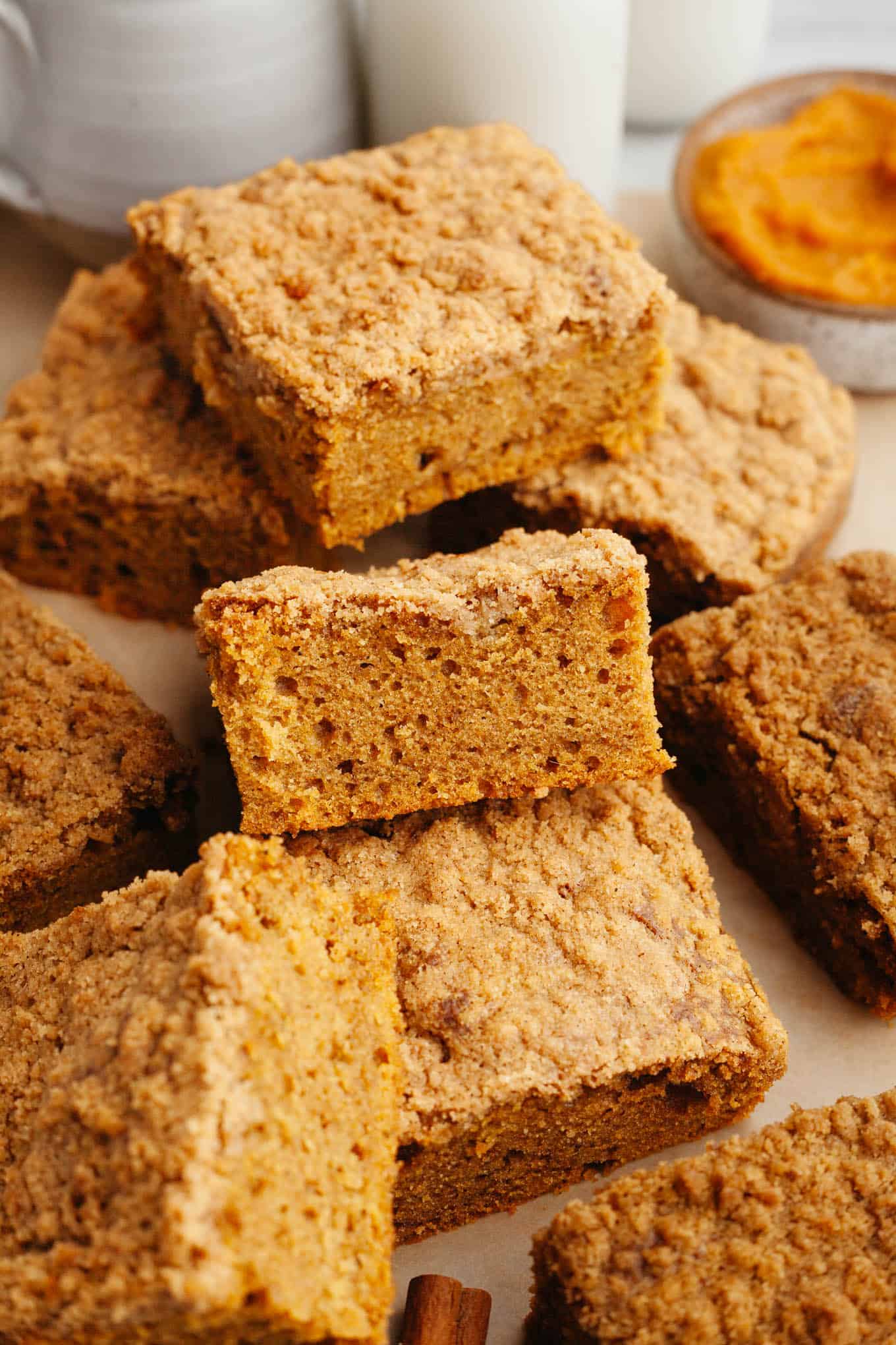 Slices of pumpkin streusel coffee cake piled on top of each other. 