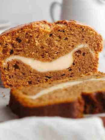A loaf of pumpkin cream cheese bread that's been sliced.