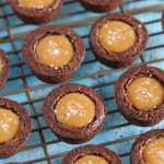 Salted caramel brownie bites sitting on top of a wire cooling rack.