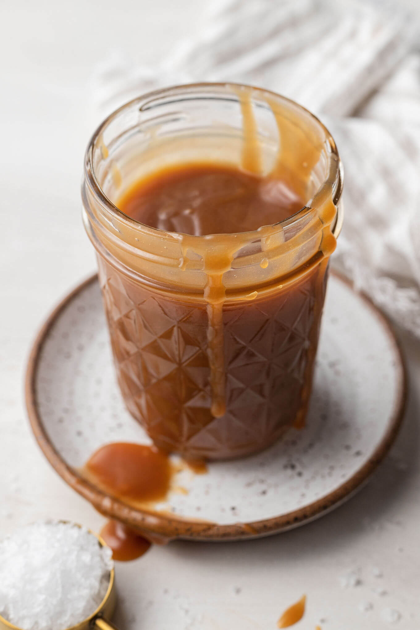 A mason jar full of homemade salted caramel sauce. 
